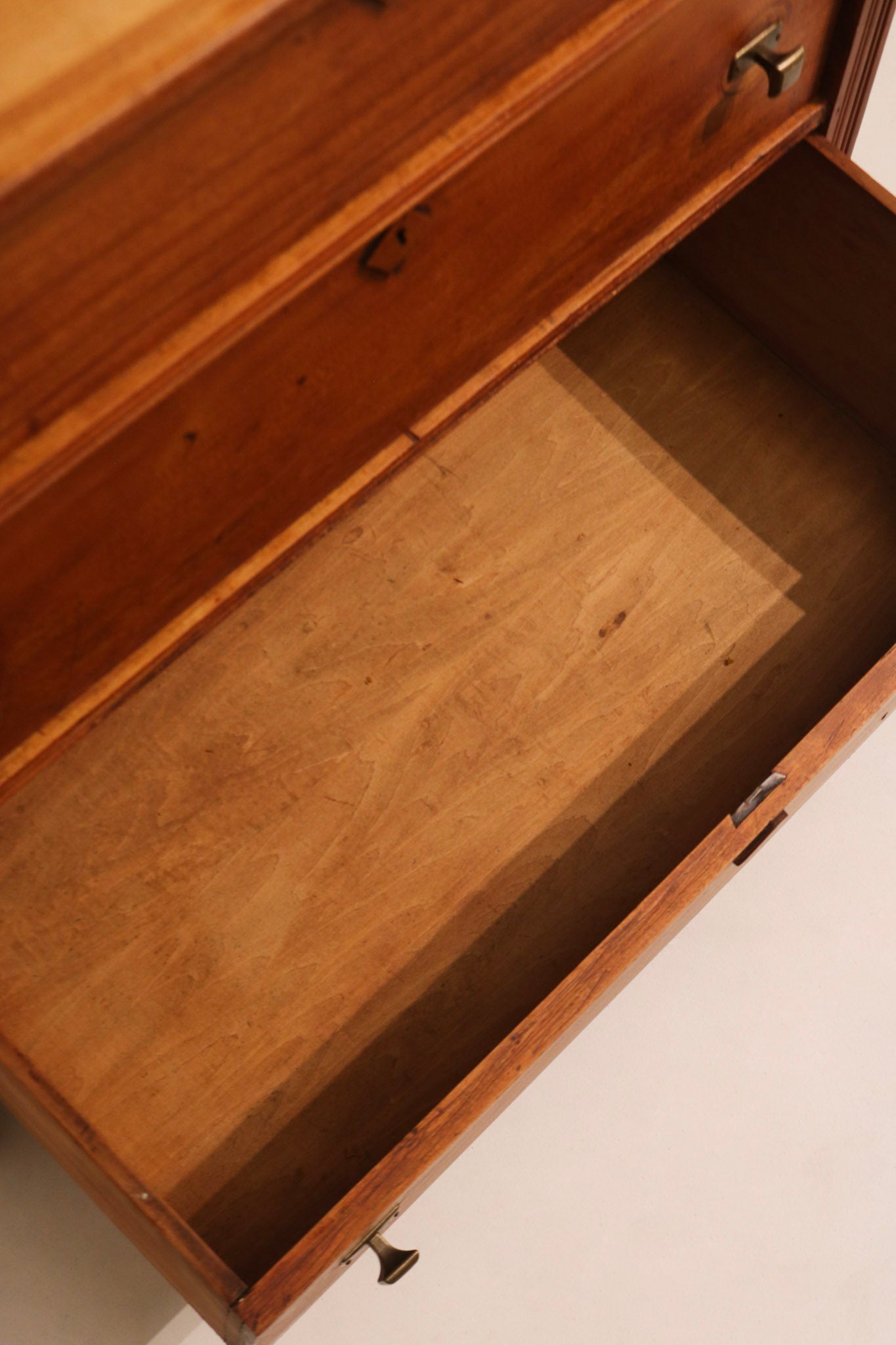 Interior view of drawer showing clean wood condition and storage space