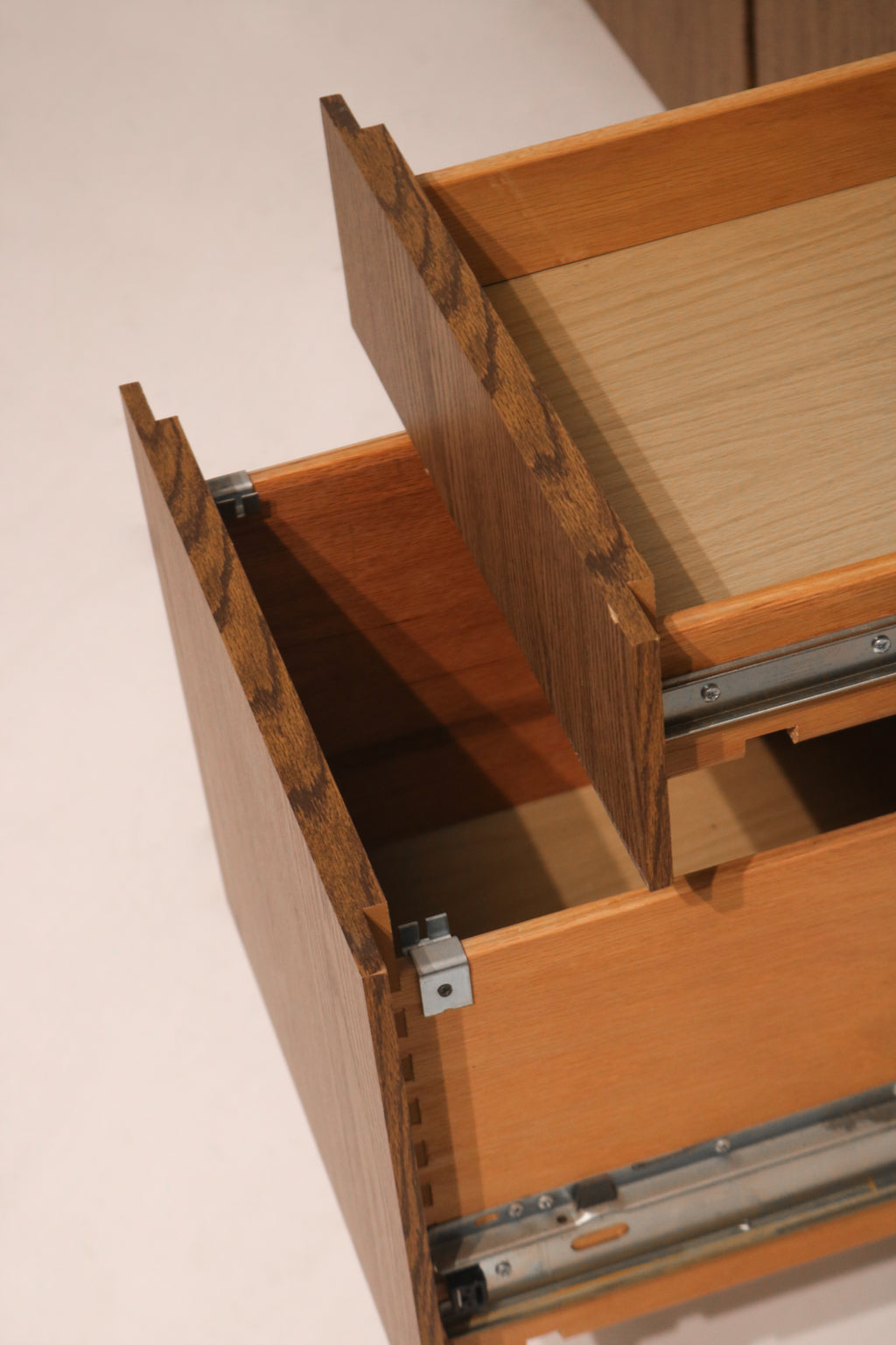 Close-up of open drawer interior showing dovetail joint construction and hardware