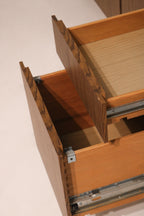 Close-up of open drawer interior showing dovetail joint construction and hardware