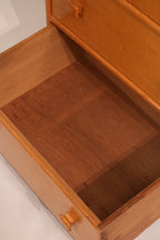 Interior view of drawer showing particle board construction and storage depth