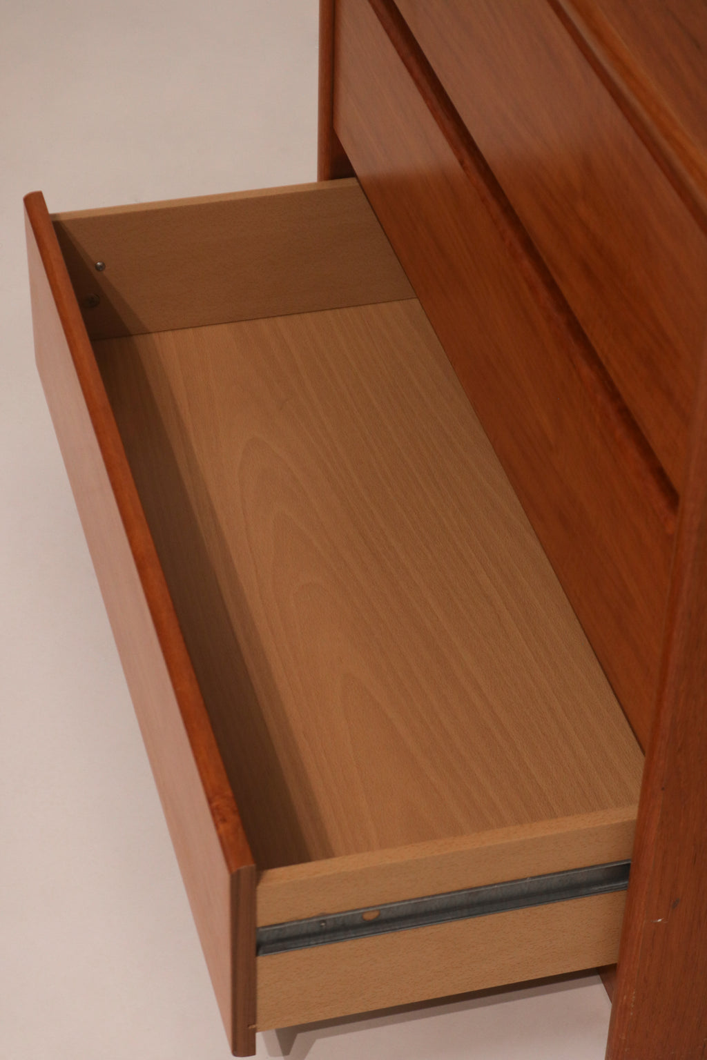 View inside drawer showing clean storage space and particle board sides