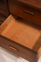 Full side profile of mid-century walnut dresser showing leg geometry and casework