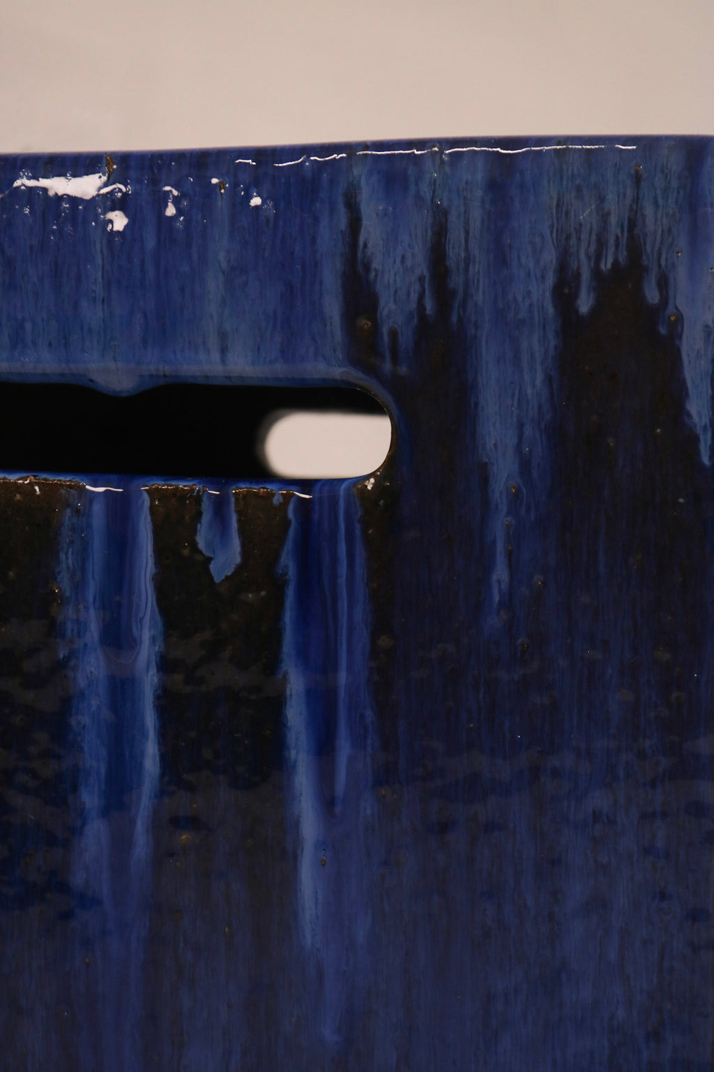 Detail of the drip glaze pattern showing contrast between blue and dark tones