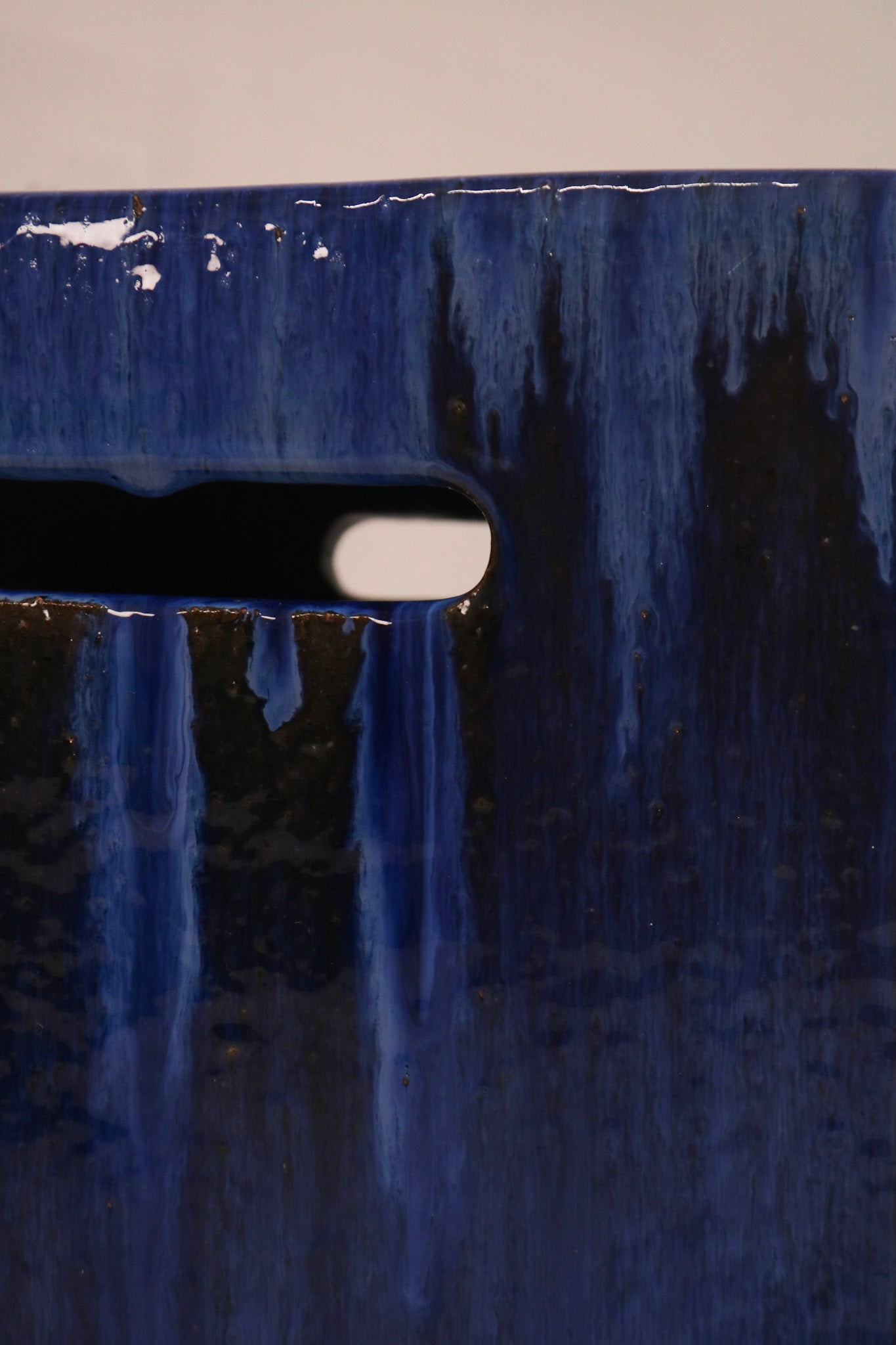 Detail of the drip glaze pattern showing contrast between blue and dark tones