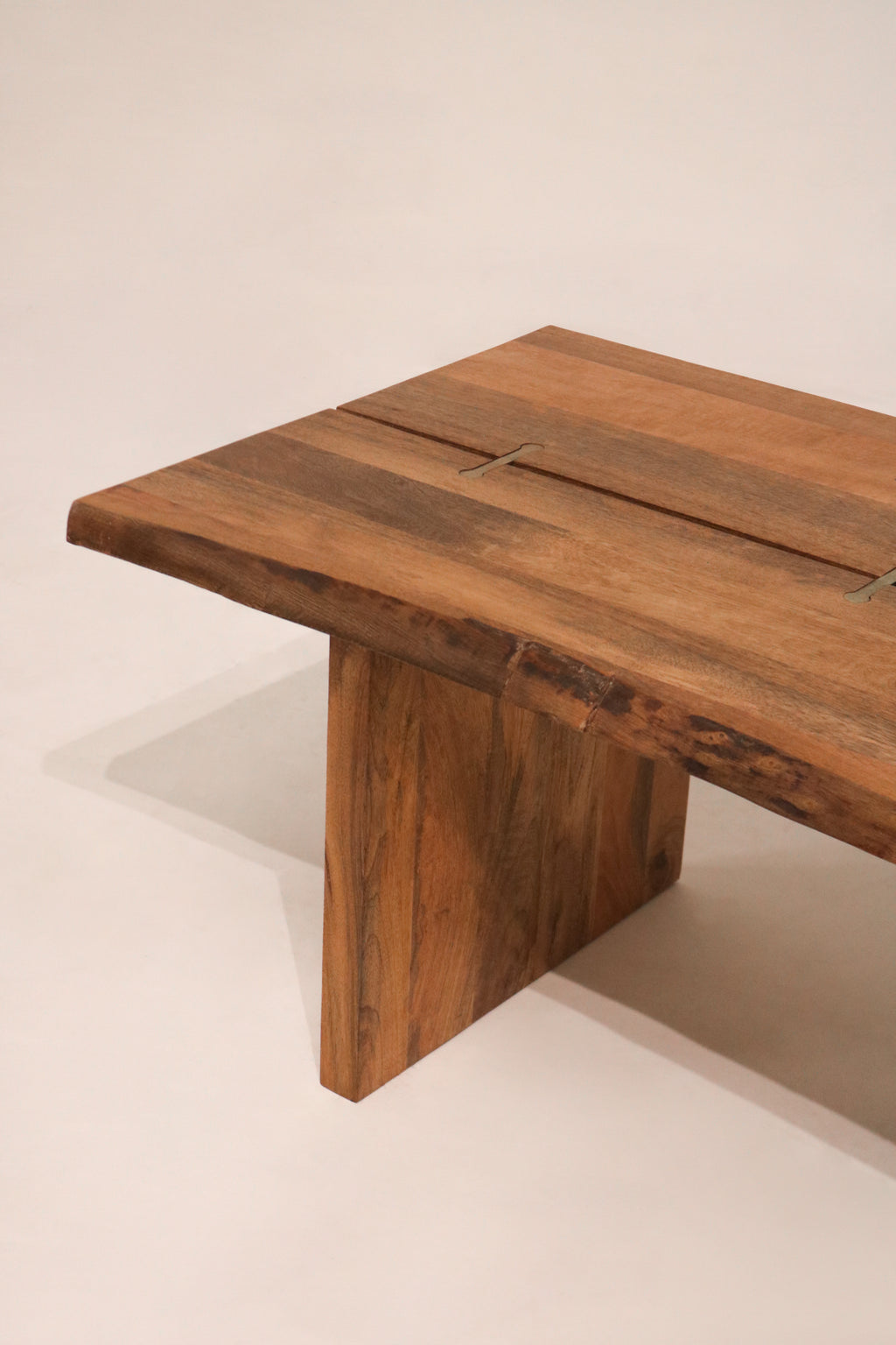 End view showing the solid plank leg construction and stability