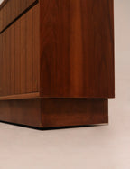 Front angle view highlighting walnut finish under studio lighting