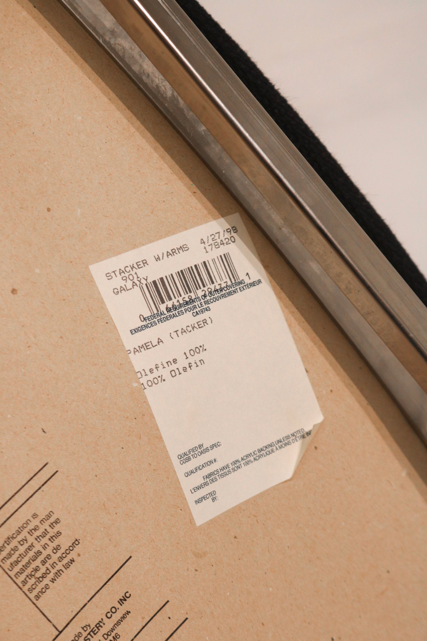 Front texture detail of black fabric seat and upright armrest chrome finish