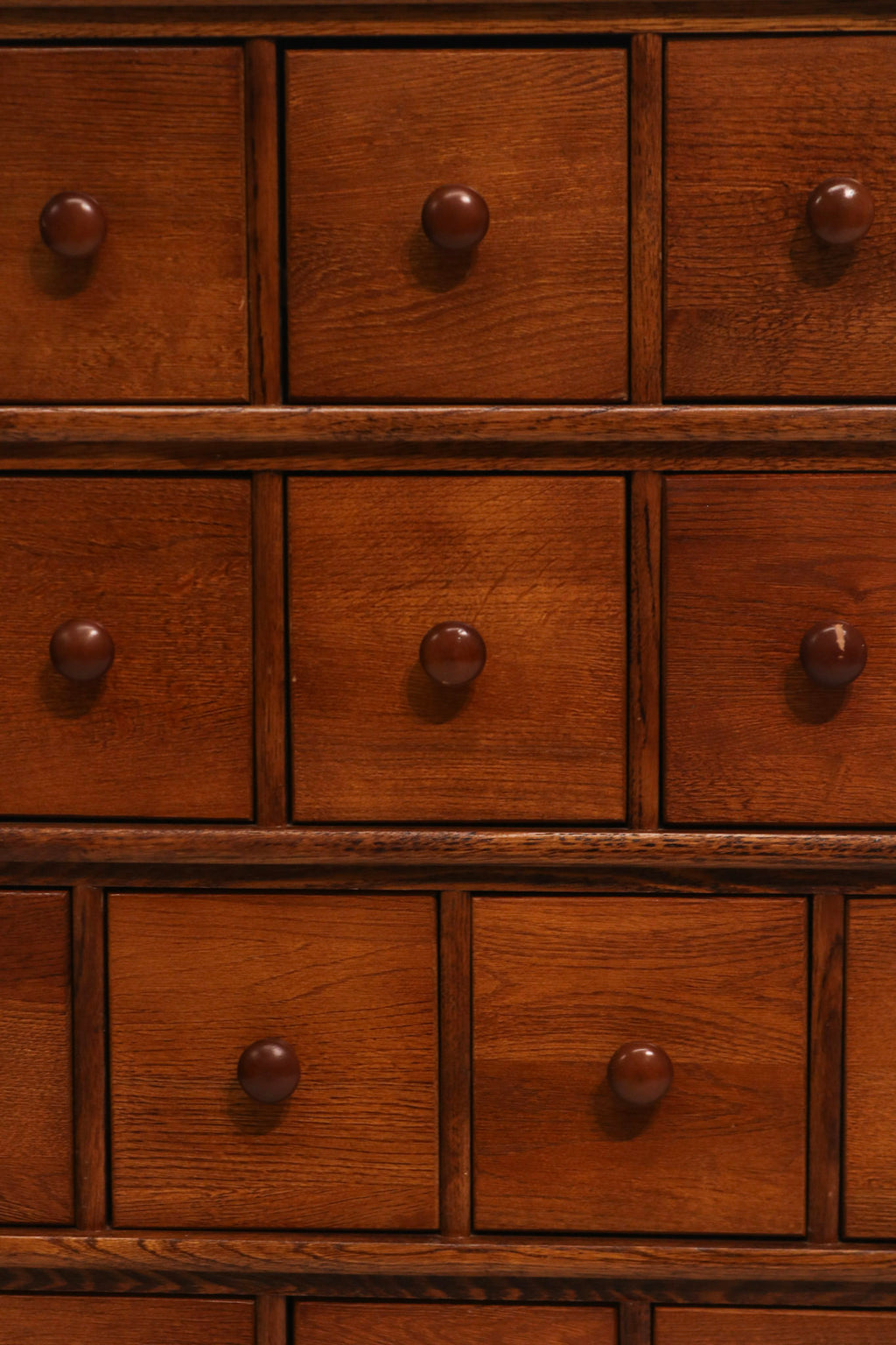 Front closeup tiered drawers showing knob hardware and oak finish