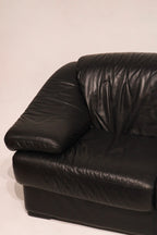 Front detail black leather upholstery showing padded cushion and armrest form