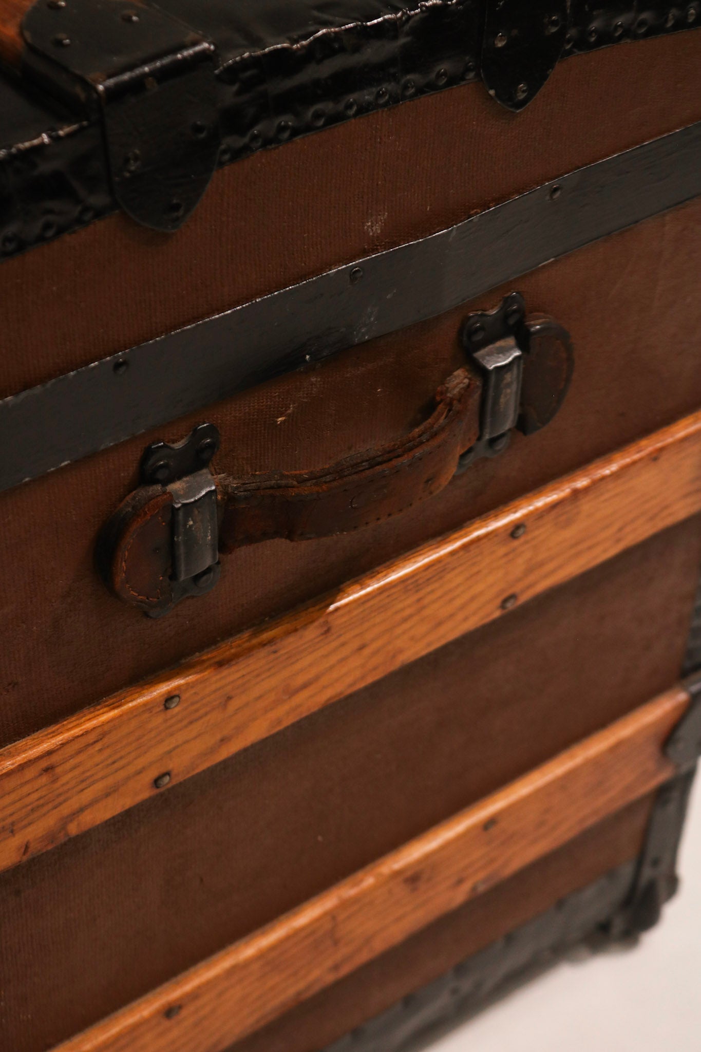 Front panel detail showing horizontal wood slats and vertical iron bands