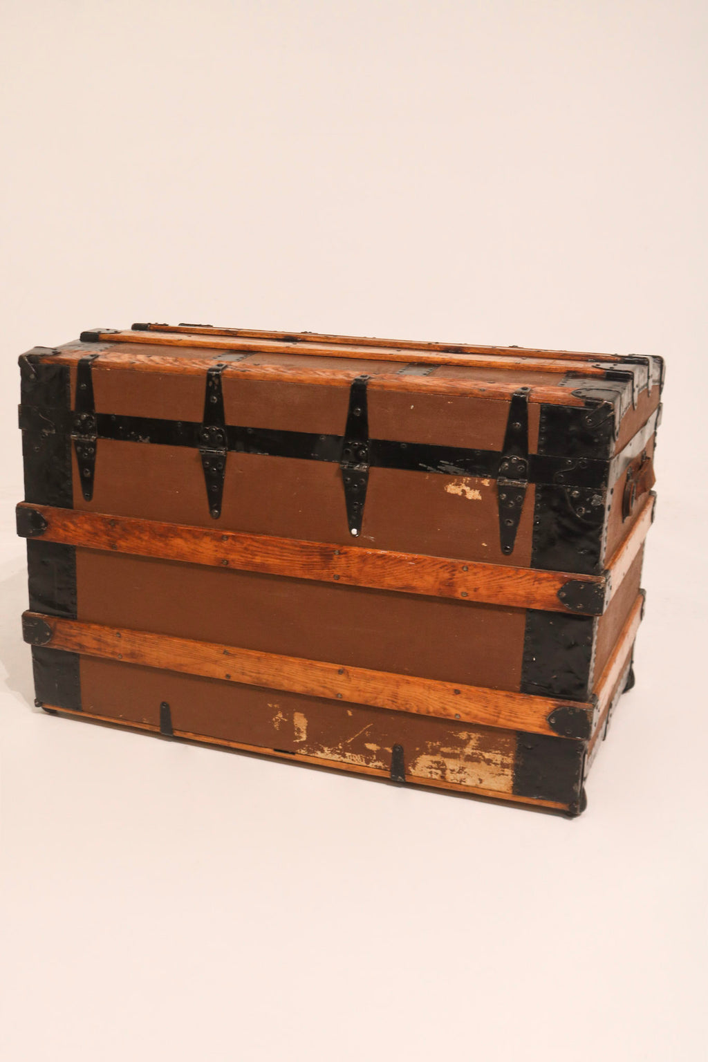 Full front view of antique chest highlighting brass lock and latch hardware