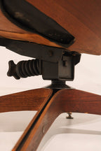 Front view of the lounge chair showcasing black tufted leather upholstery