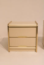Front view of single nightstand with two drawers and gold accents