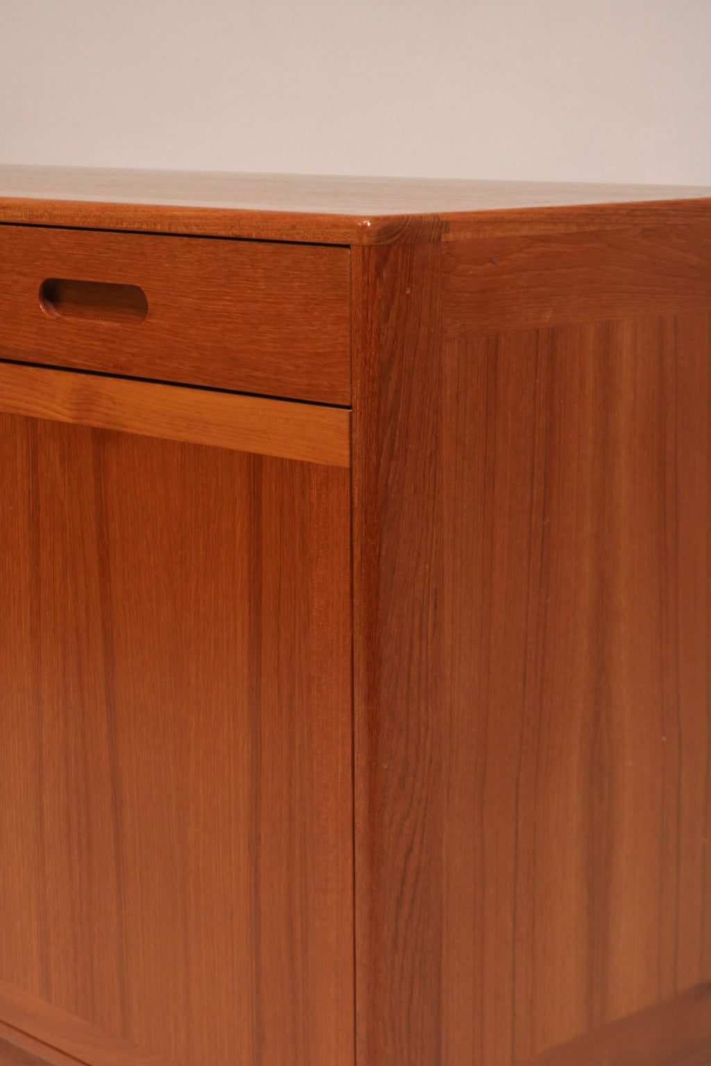 Full frontal view of the minimalist teak credenza showing symmetry