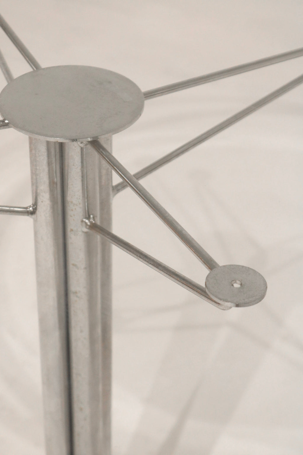 Close-up of the mounting plate connecting the glass top to the base