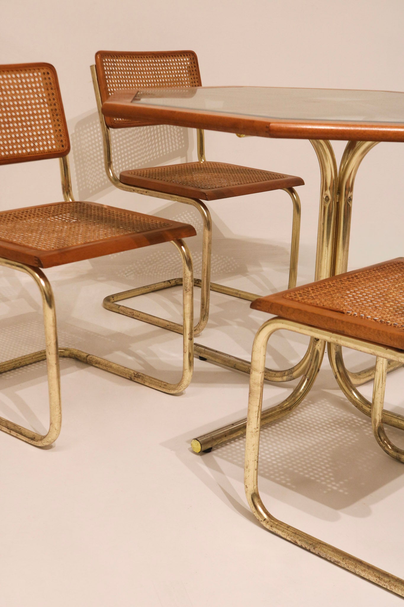 Detail of glass table top corner inserted in wood frame