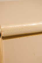 Close-up detail showing wear and condition of the gold metal trim edge
