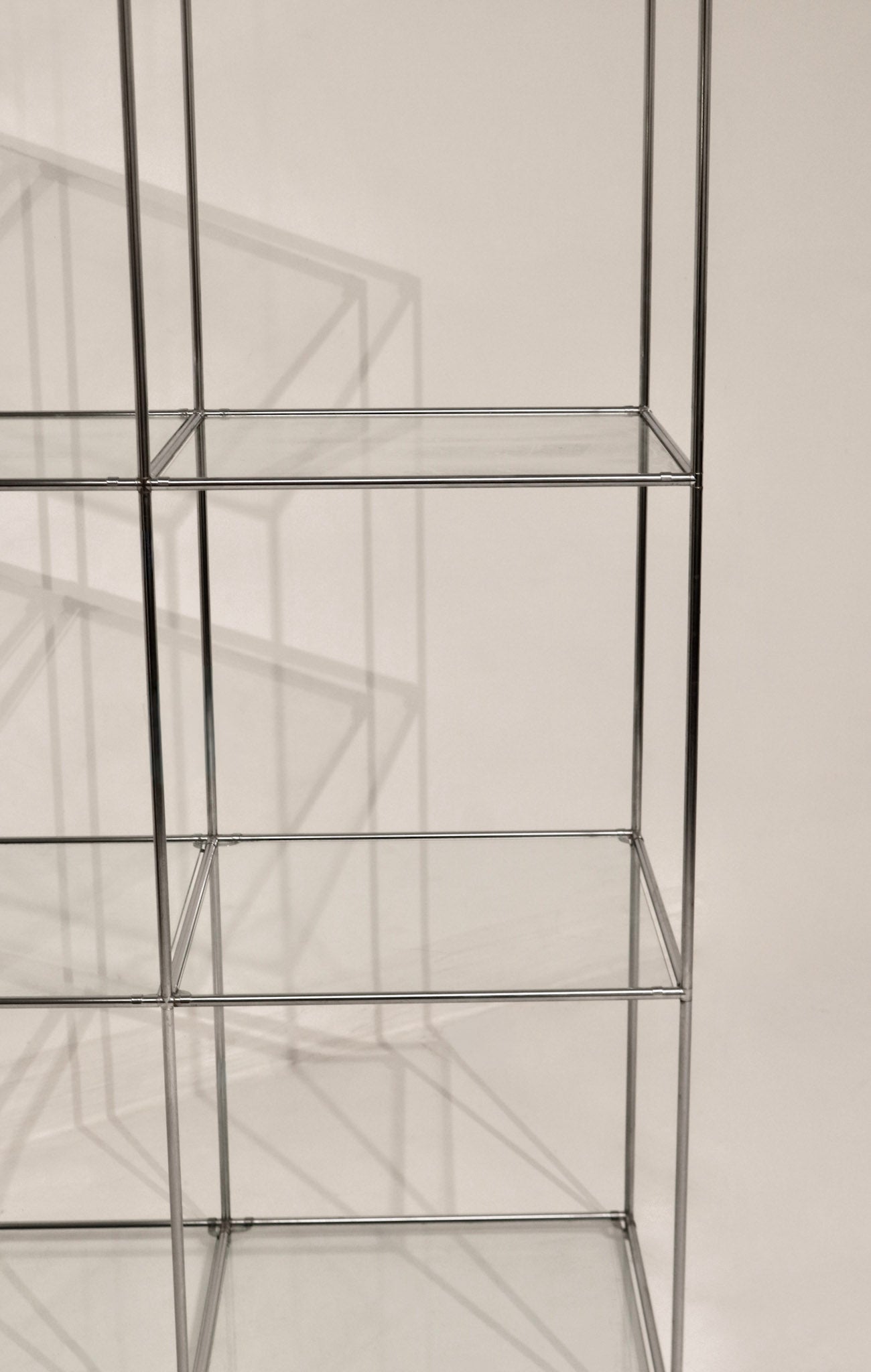 View of the grid structure and glass shelves arrangement looking through