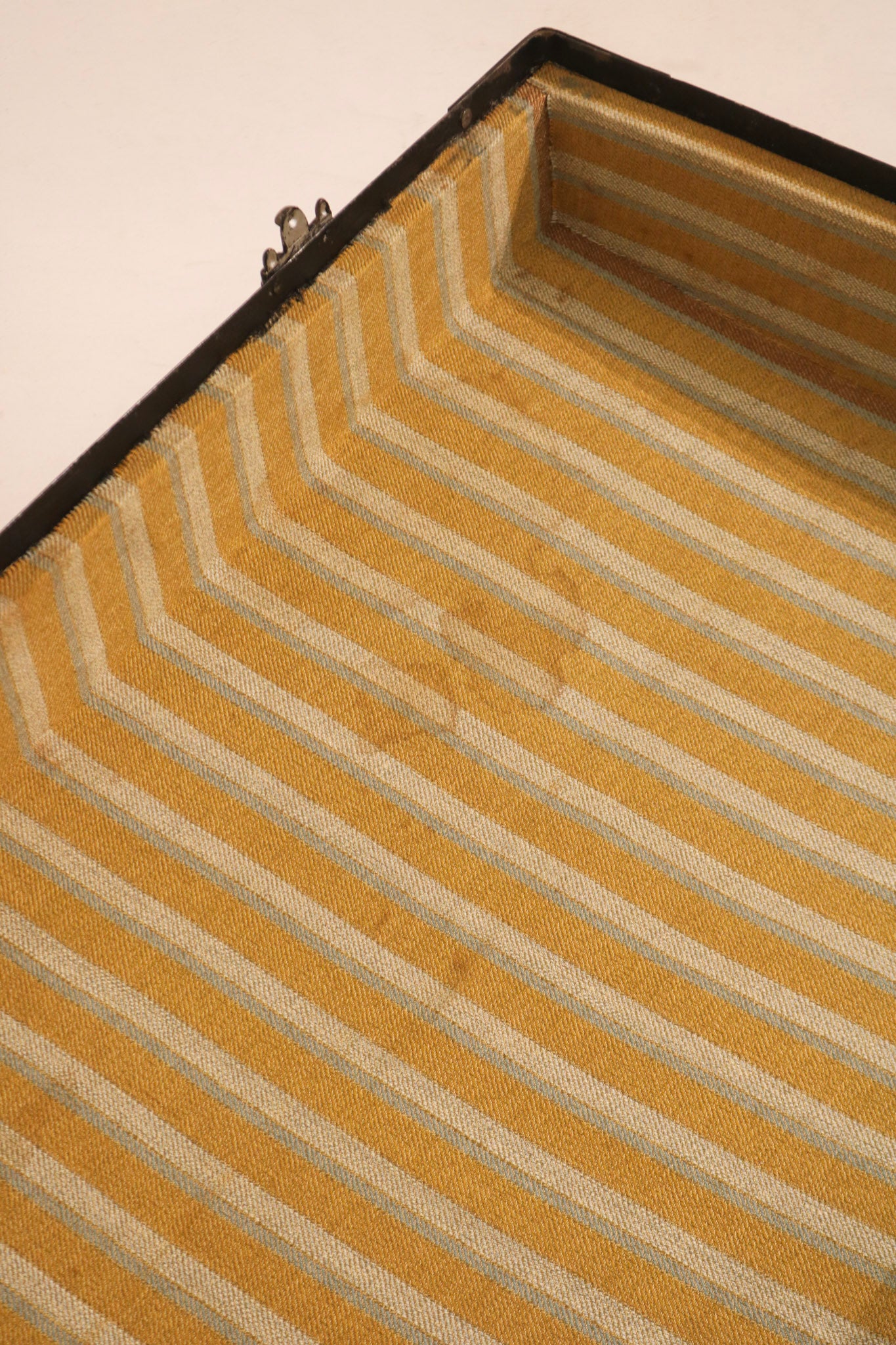 Detail of interior fabric lining condition showing yellow and white stripes