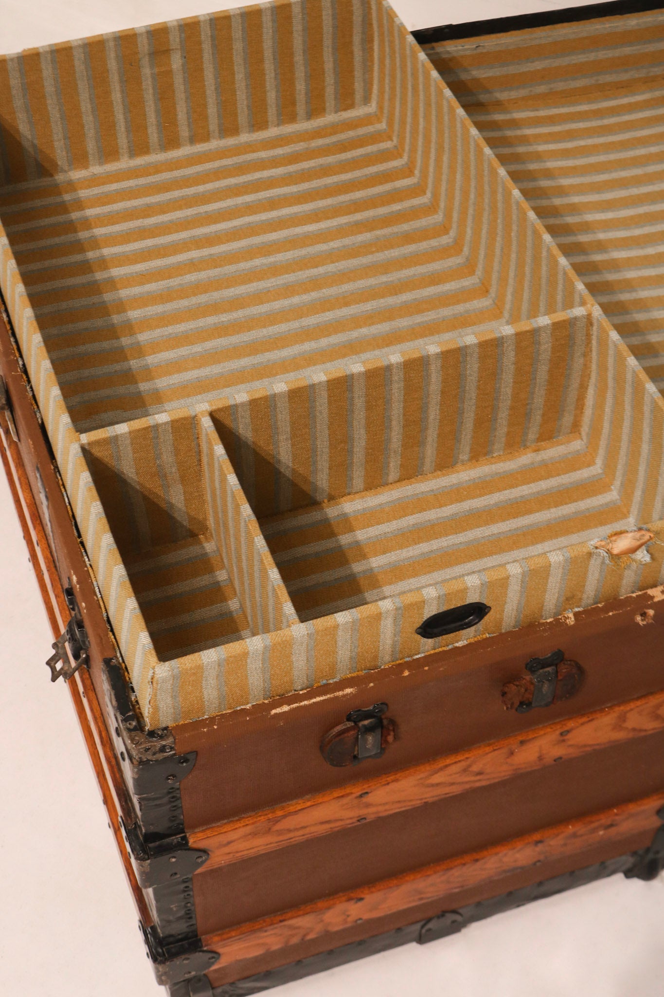 Interior tray organization detail with vintage striped fabric lining