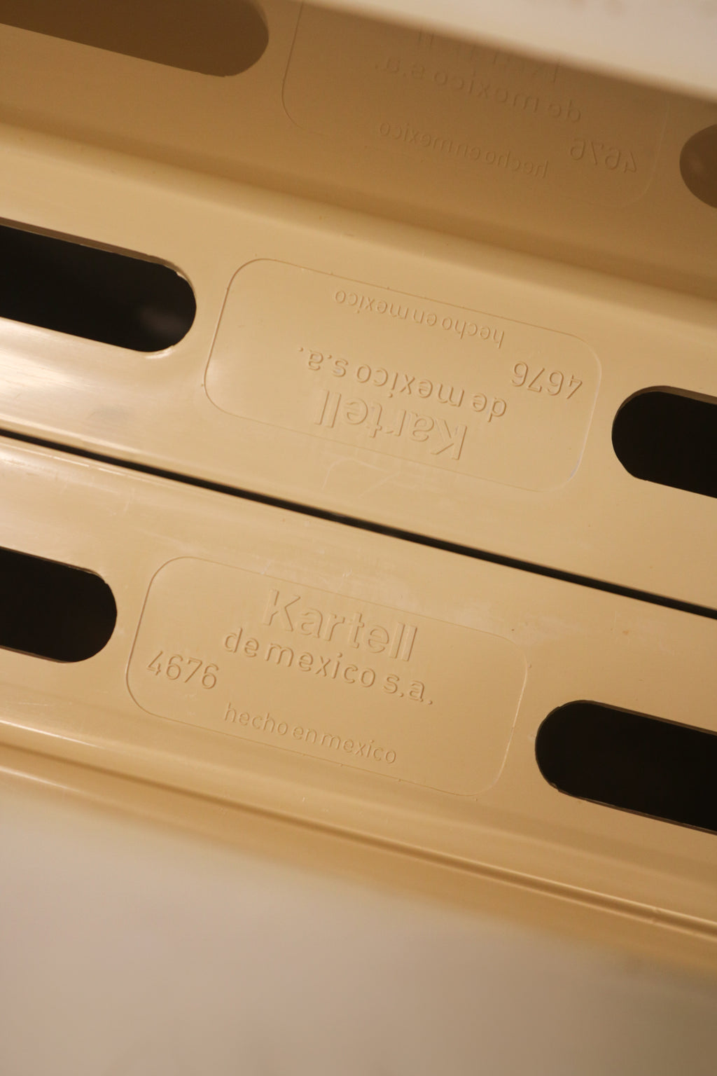 Close-up of Kartell brand mark or construction detail verifying authenticity