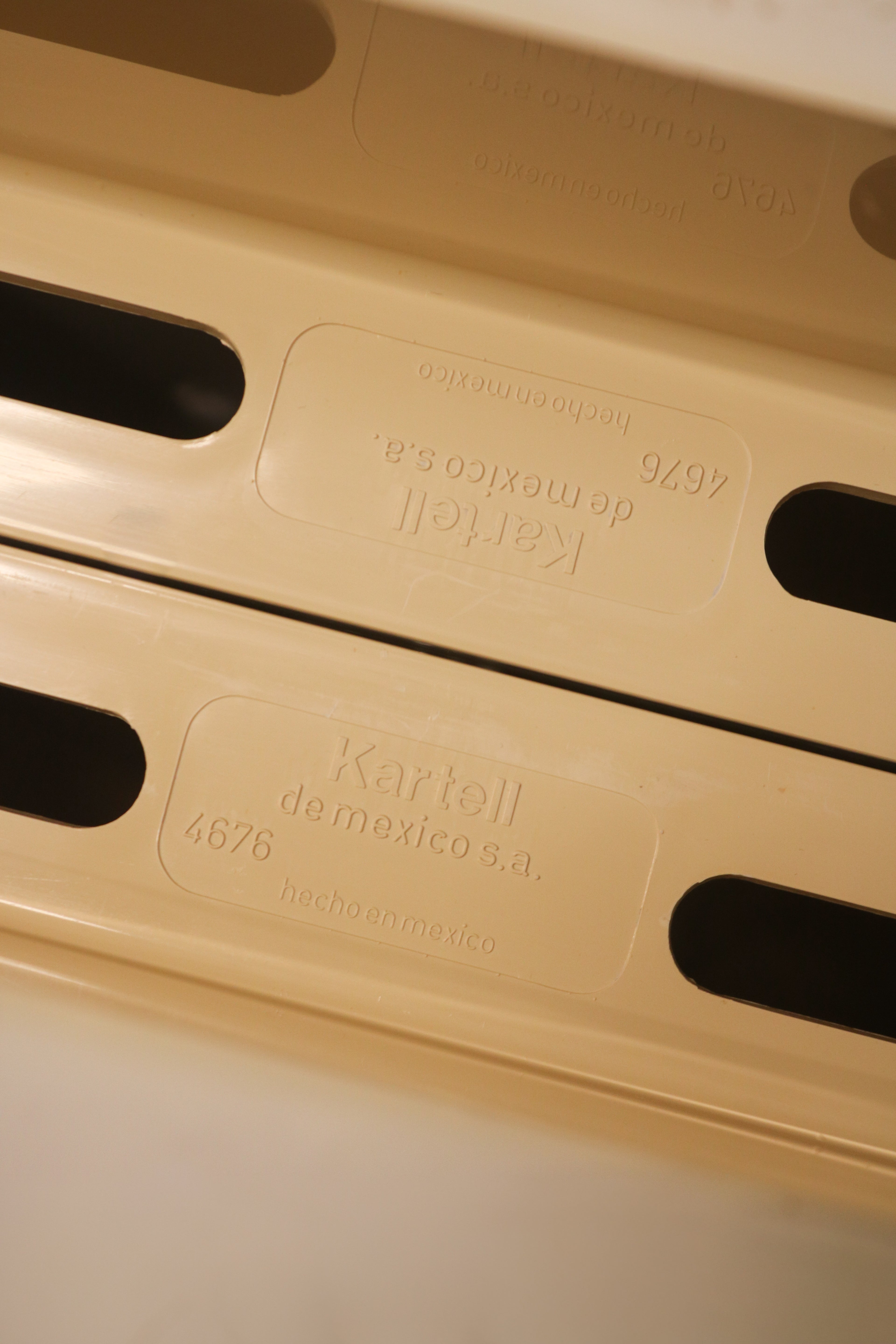 Close-up of Kartell brand mark or construction detail verifying authenticity