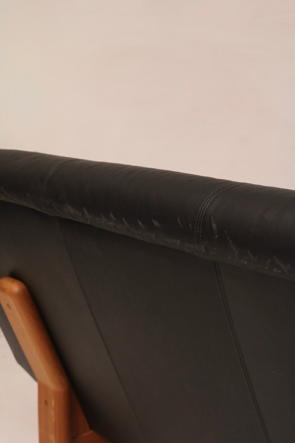 Close-up of black leather backrest stitching and condition