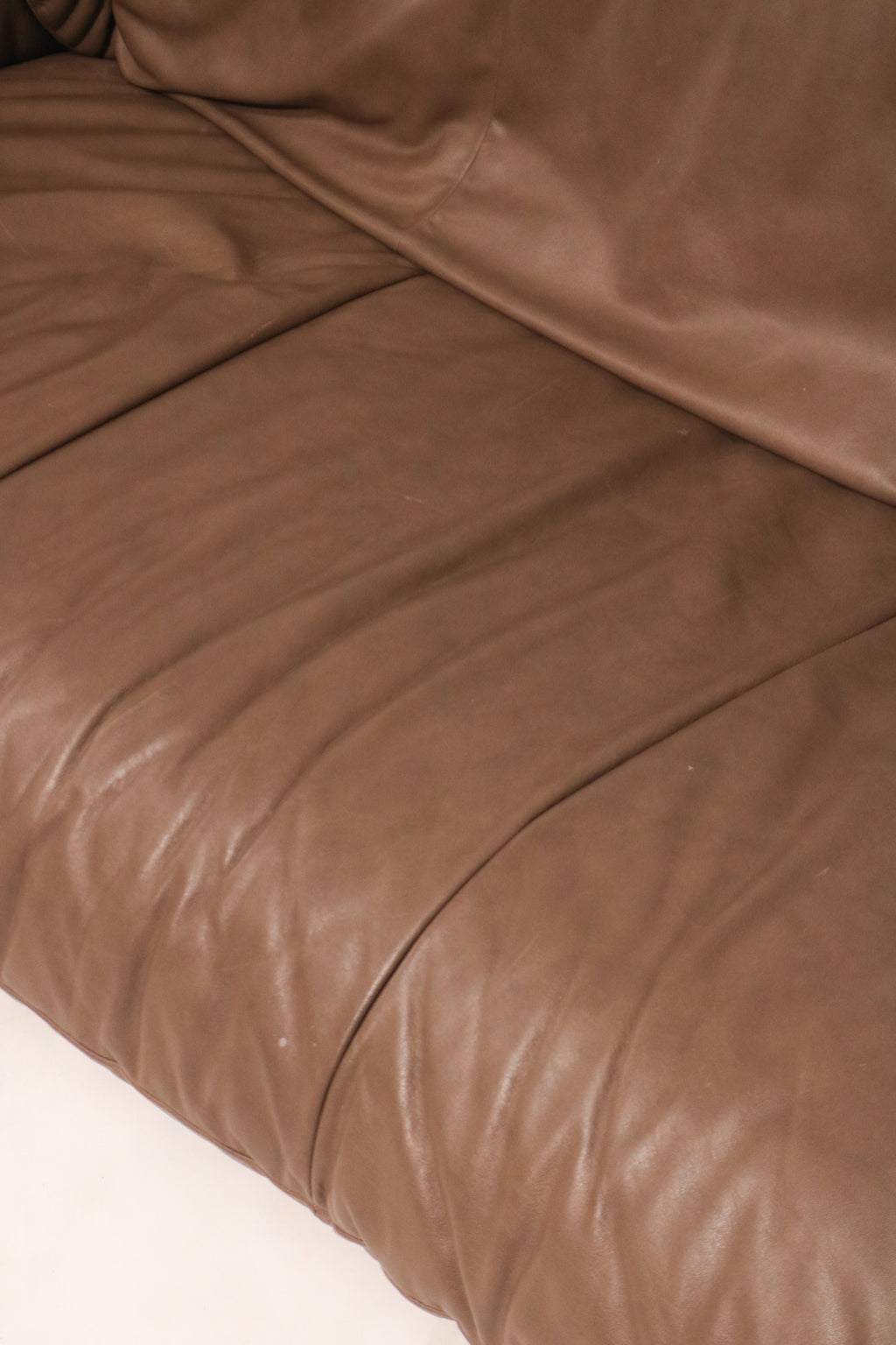 Close-up of the leather seat cushion showing wear and condition