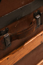 Close-up of leather side handle with iron mounting hardware