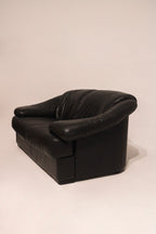 Close-up of left armrest showing genuine leather and light marks minimal wear