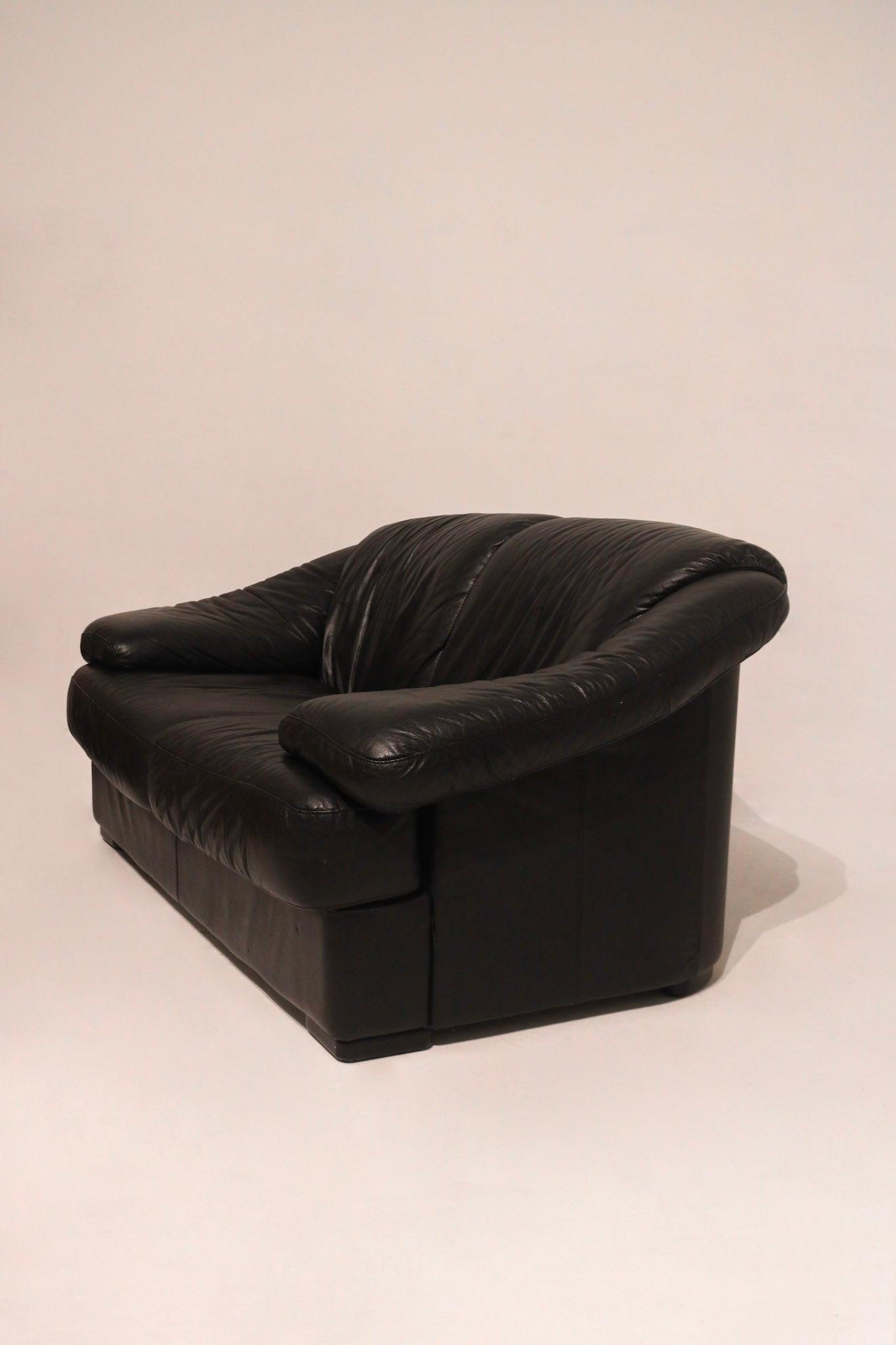 Close-up of left armrest showing genuine leather and light marks minimal wear