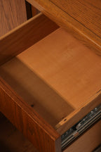Detail of the left cabinet door showing oak wood grain pattern