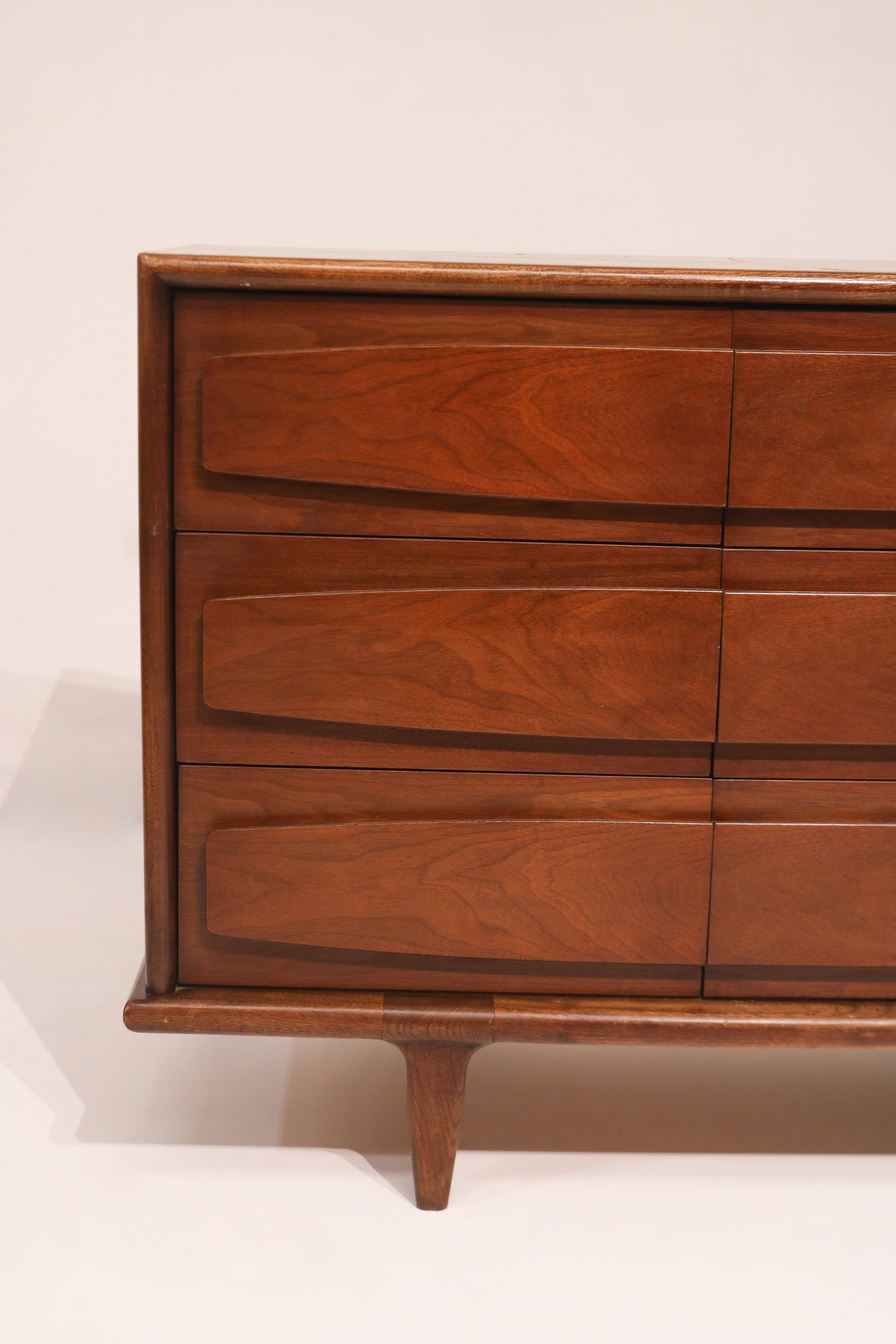 View of left side drawers featuring signature sculpted wood pulls