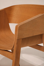 Left side angle highlighting prismatic leg geometry and seat attachment