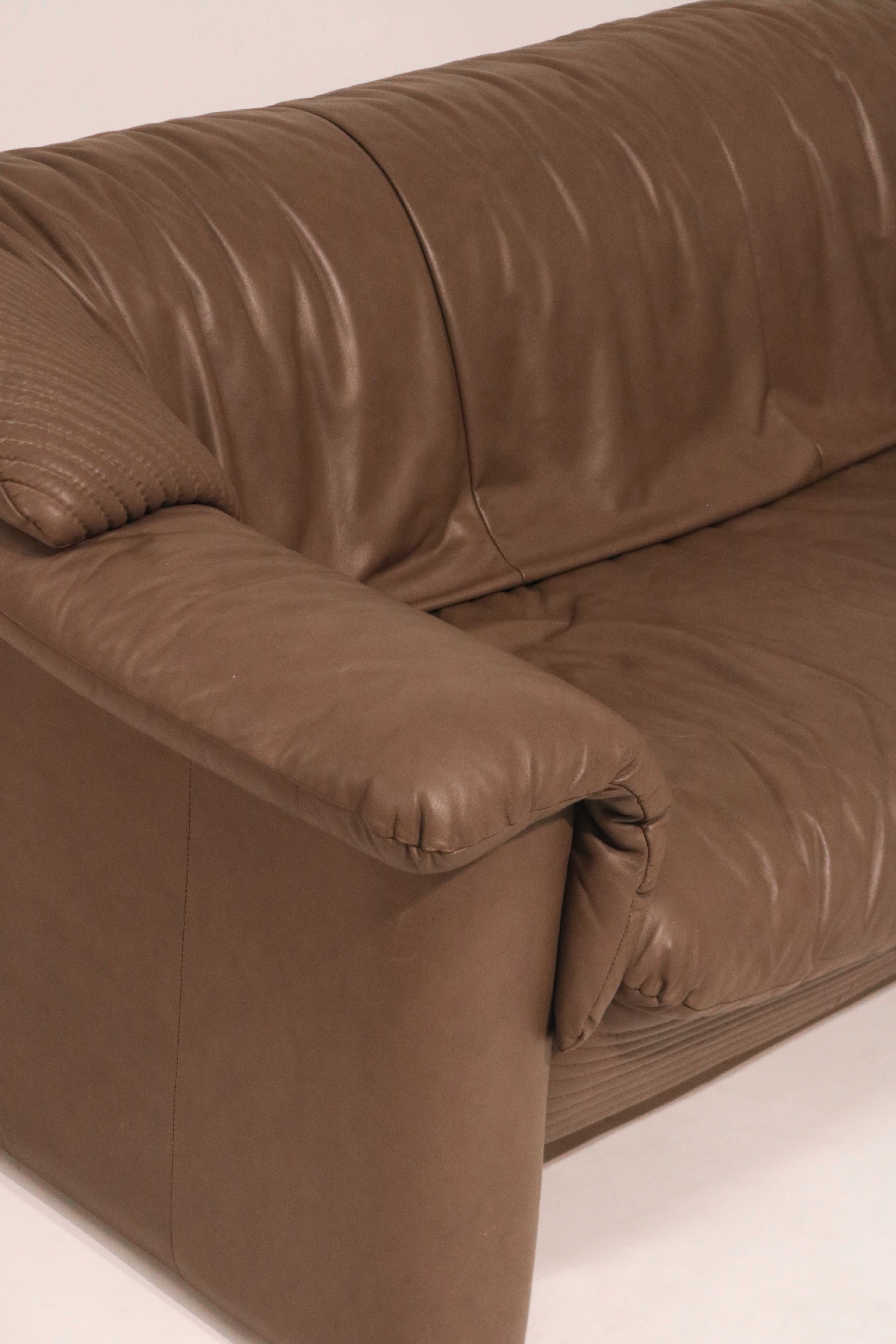 Left side view of the loveseat showing structure and leather paneling