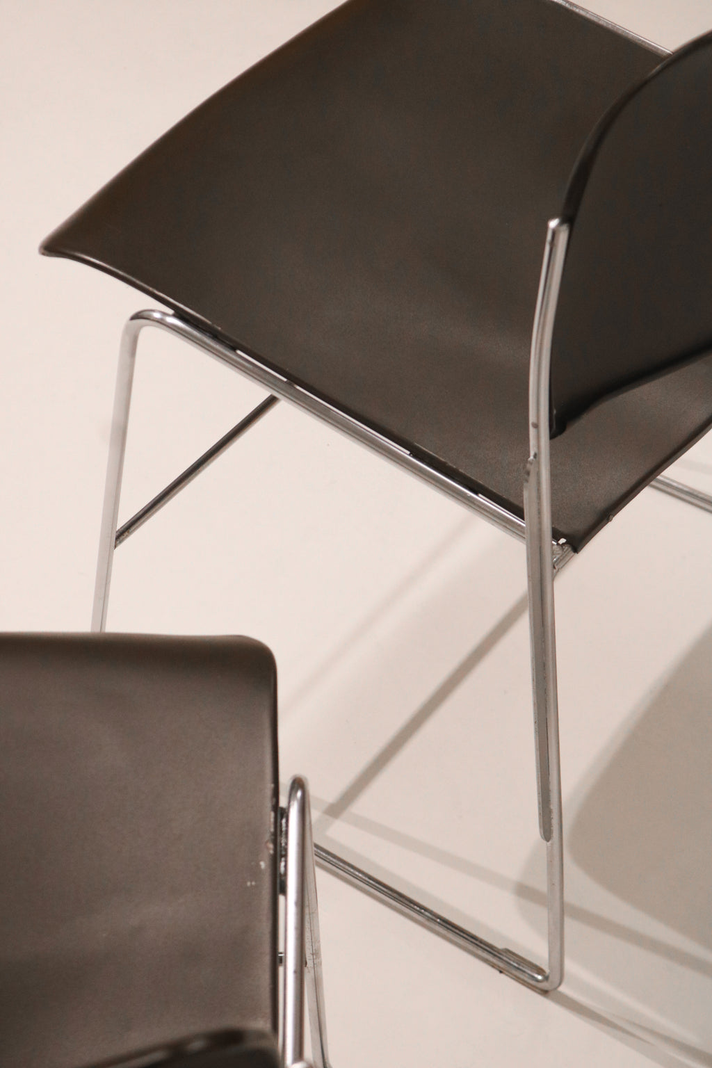Low angle view highlighting the geometric chrome frame design of the chair