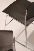 Low angle view highlighting the geometric chrome frame design of the chair