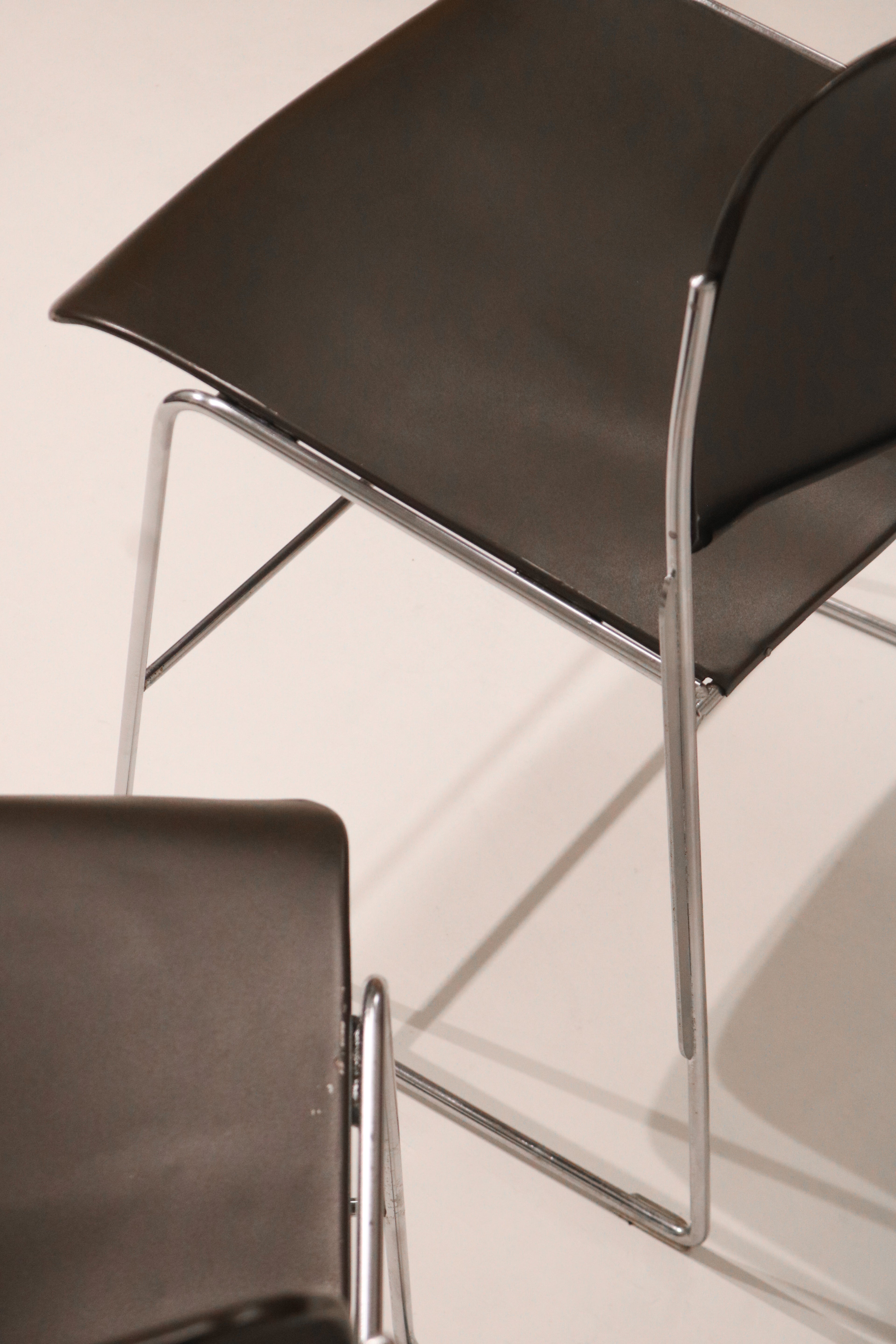 Low angle view highlighting the geometric chrome frame design of the chair