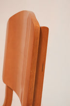 Low angle view emphasizing the ergonomic curve of the plywood seat