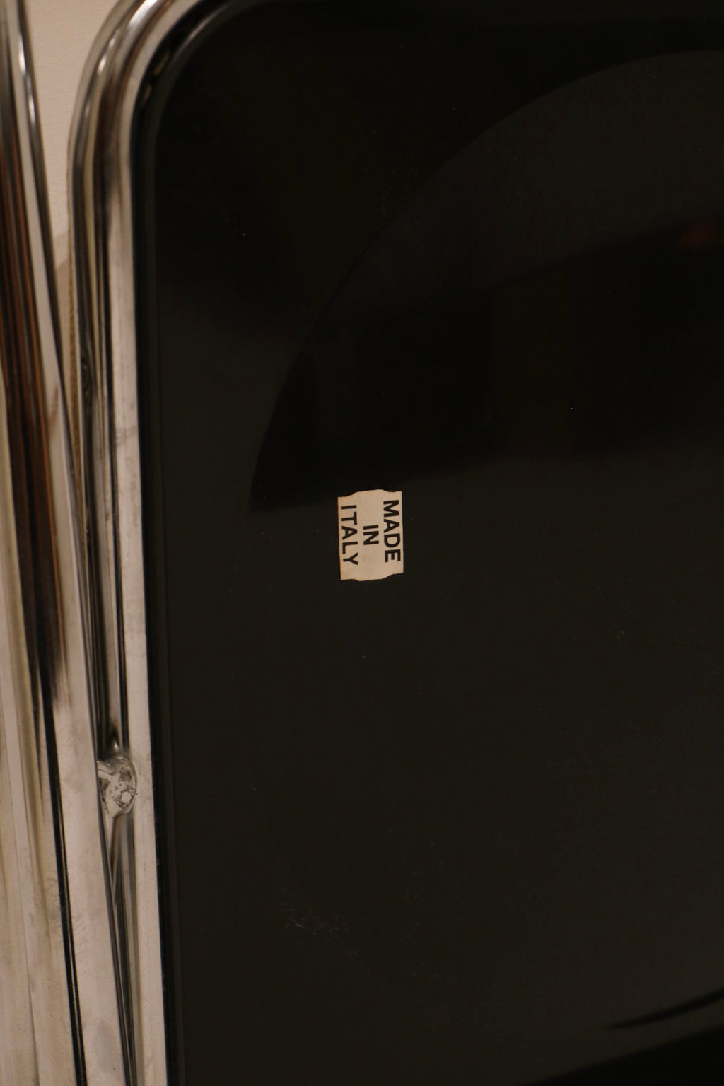 Made in Italy sticker detail on black back panel verifying origin