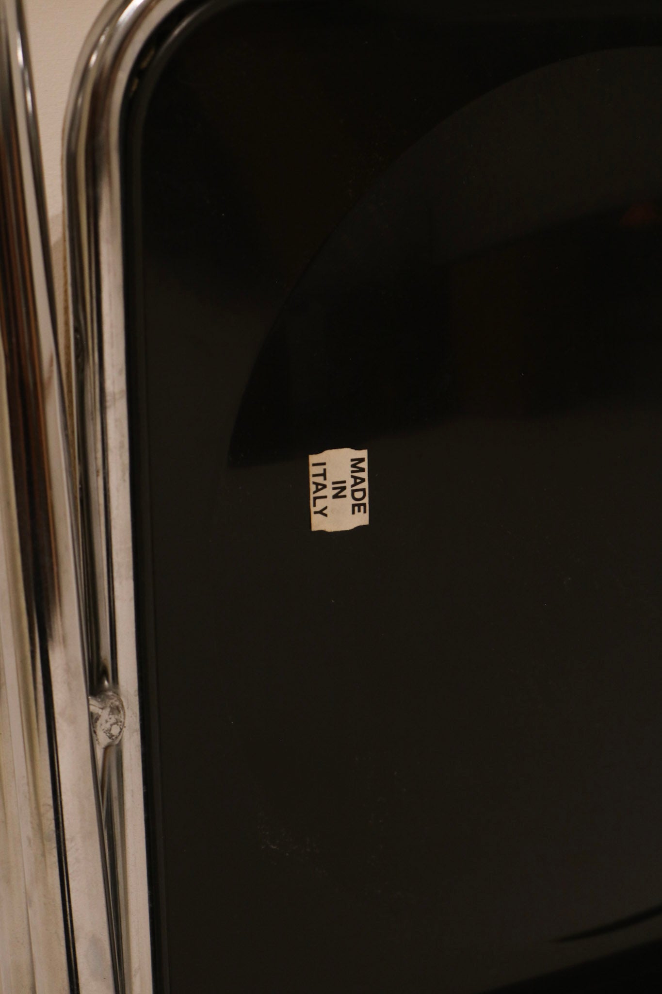 Made in Italy sticker detail on black back panel verifying origin