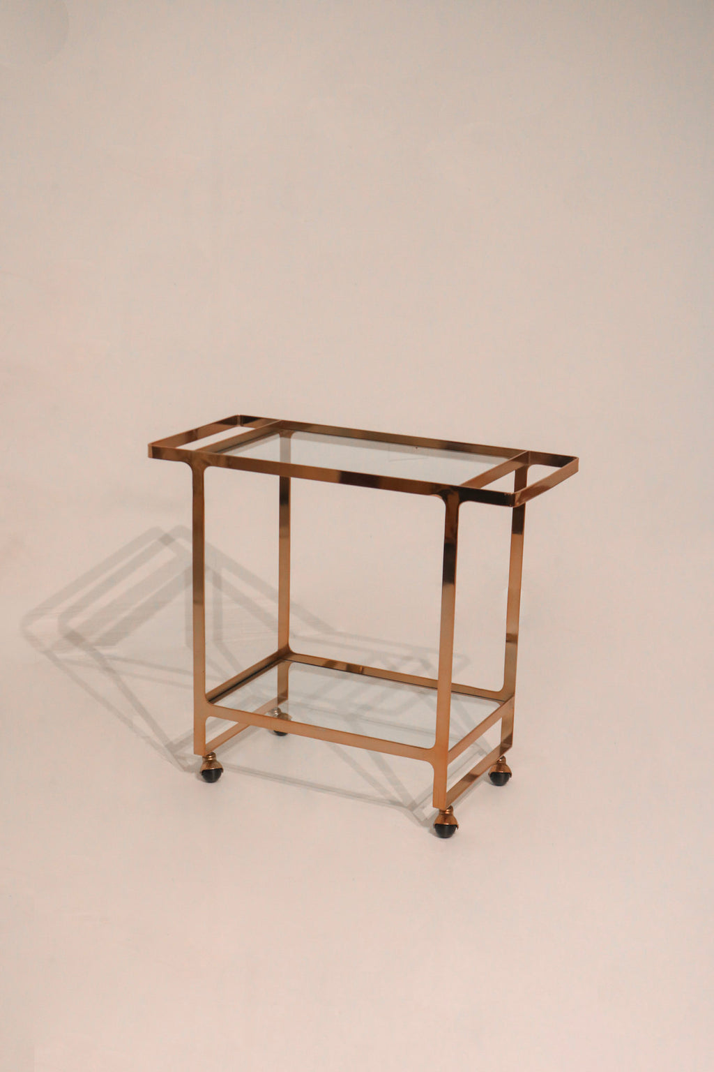 CB2 brass rose gold glass bar serving cart on wheels 35x16x31 inches modern design