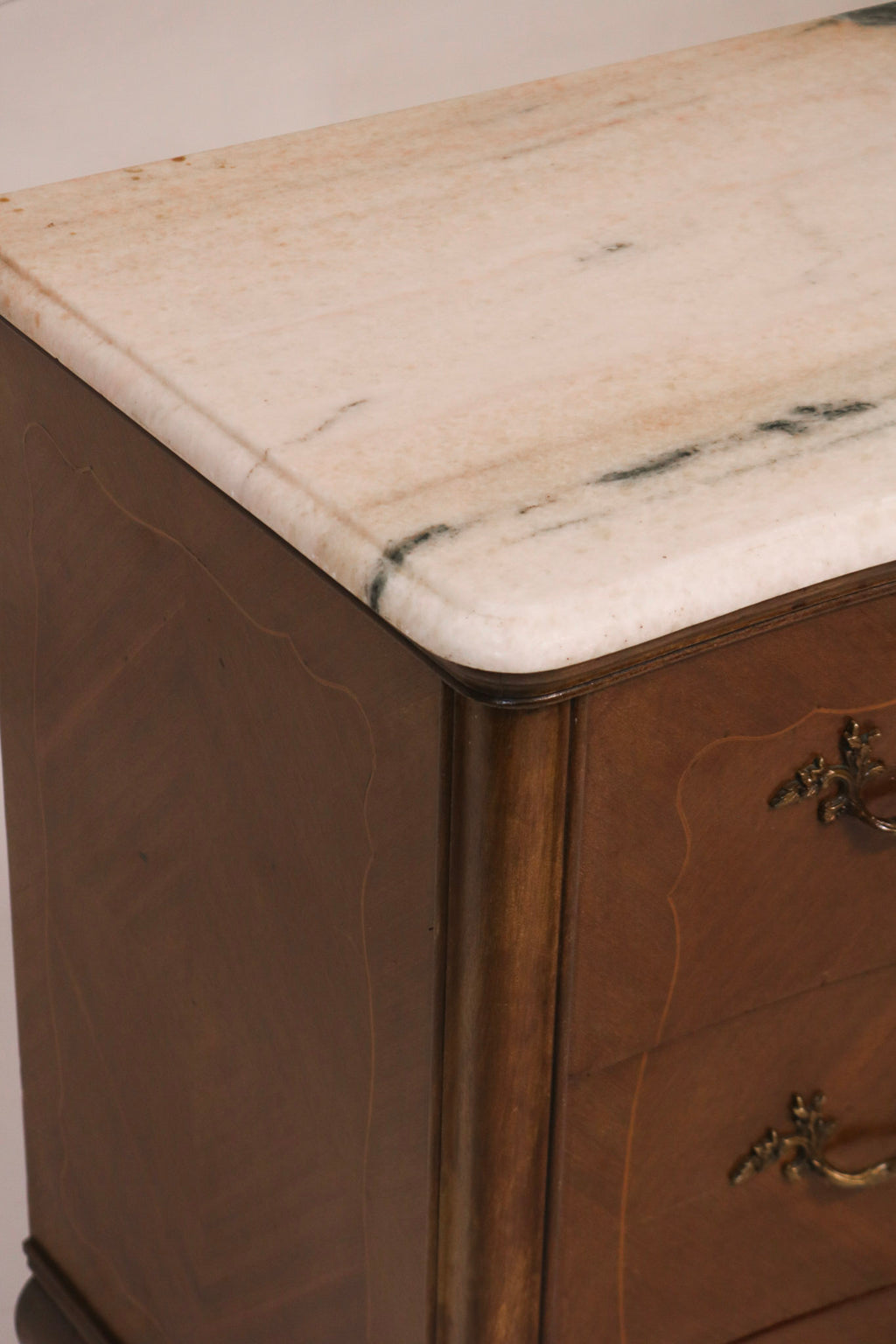Close-up of marble top corner edge and wood molding detail
