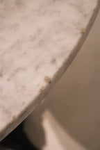 Close-up of marble top edge showing small chips (as noted in condition)