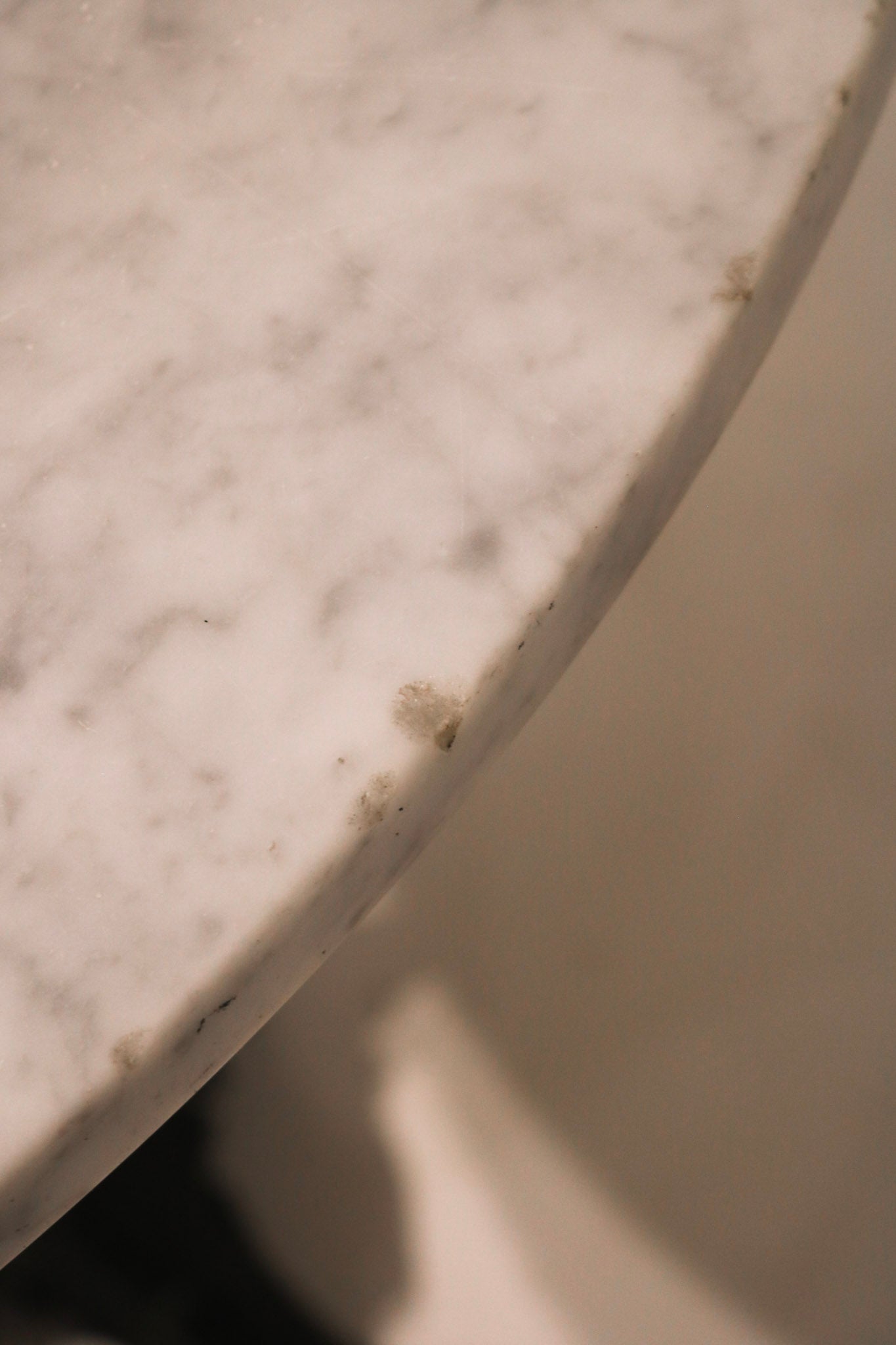 Close-up of marble top edge showing small chips (as noted in condition)