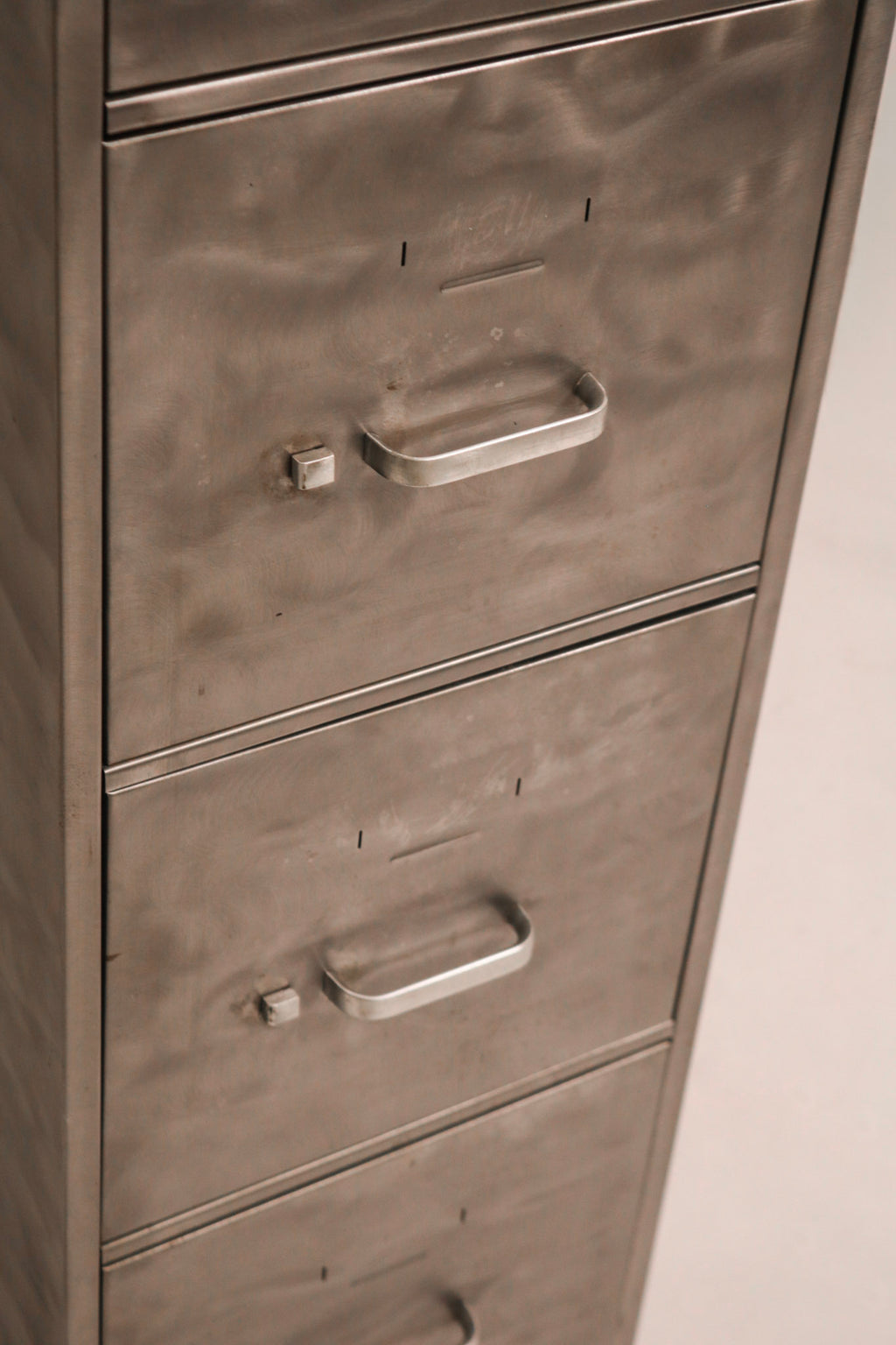 Close-up of industrial style metal handle hardware and label holder