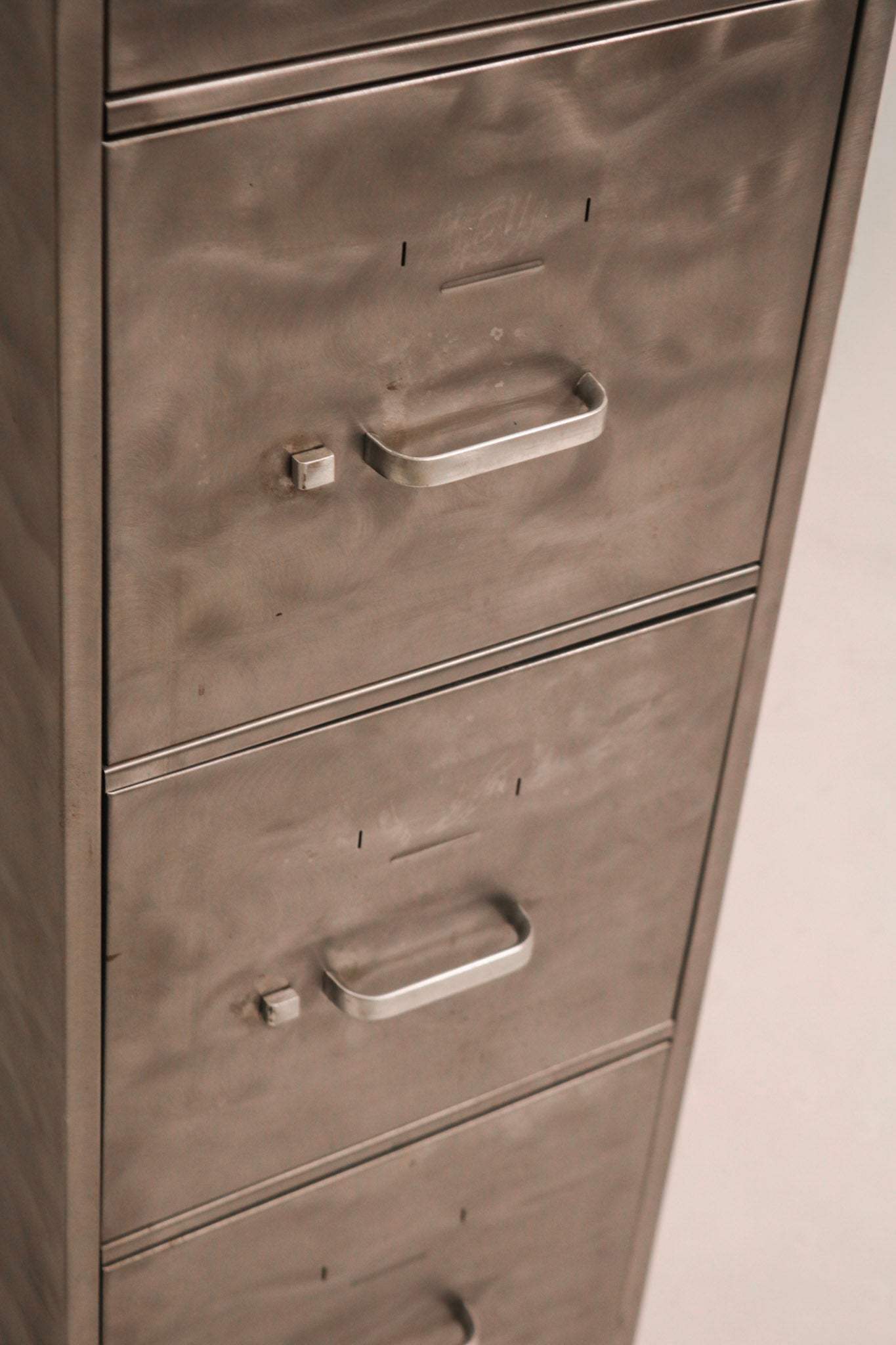 Close-up of industrial style metal handle hardware and label holder