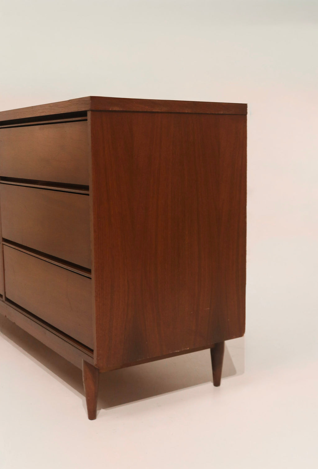 Close-up detail of minor veneer chip or damage (as noted in condition)