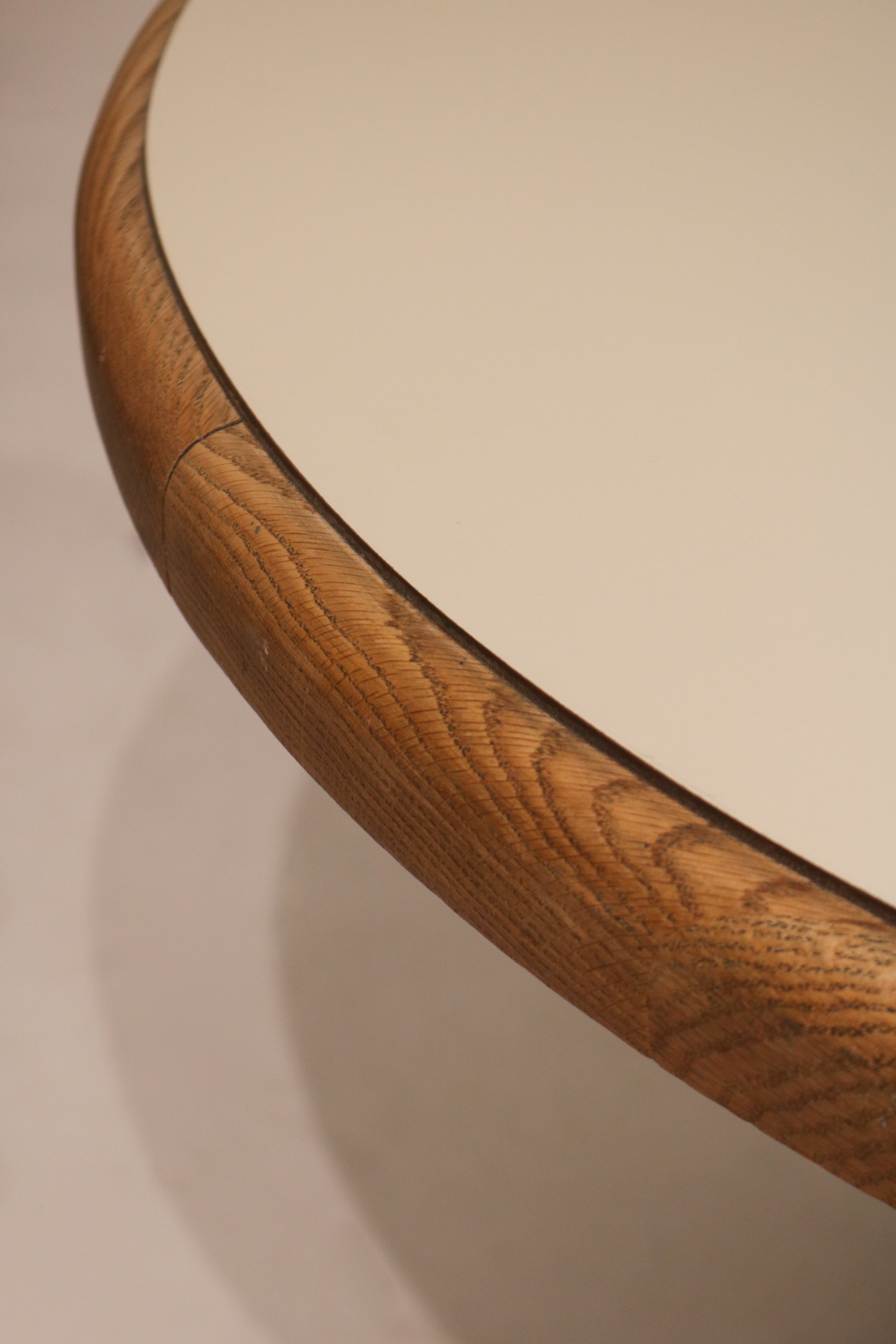 Edge profile detail showing oak wood border and white formica table top