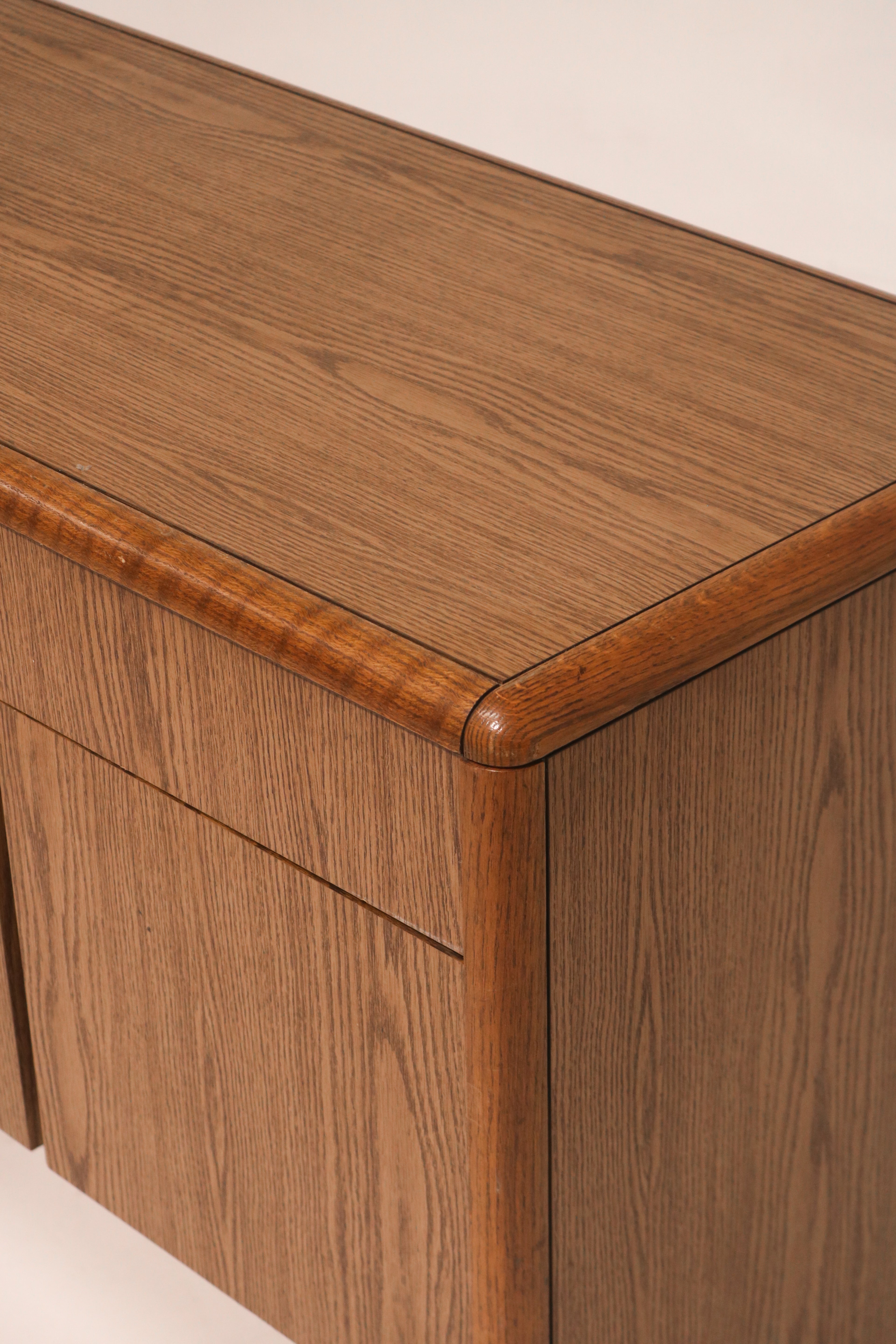 Detail of top edge trim showing solid oak finish and craftsmanship